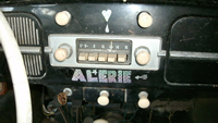 Dash with ignition, ash tray, and radio, front view.
