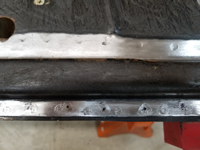 Welds marked with a dot that need to be drilled out.