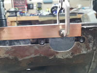 Copper bar used to keep welds from blowing out on the edges of the pedal cluster support plate.